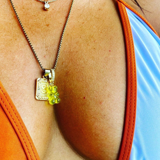girl model wearing a yellow gummy bear pendant on a gold chain - Gummy Bear Bling