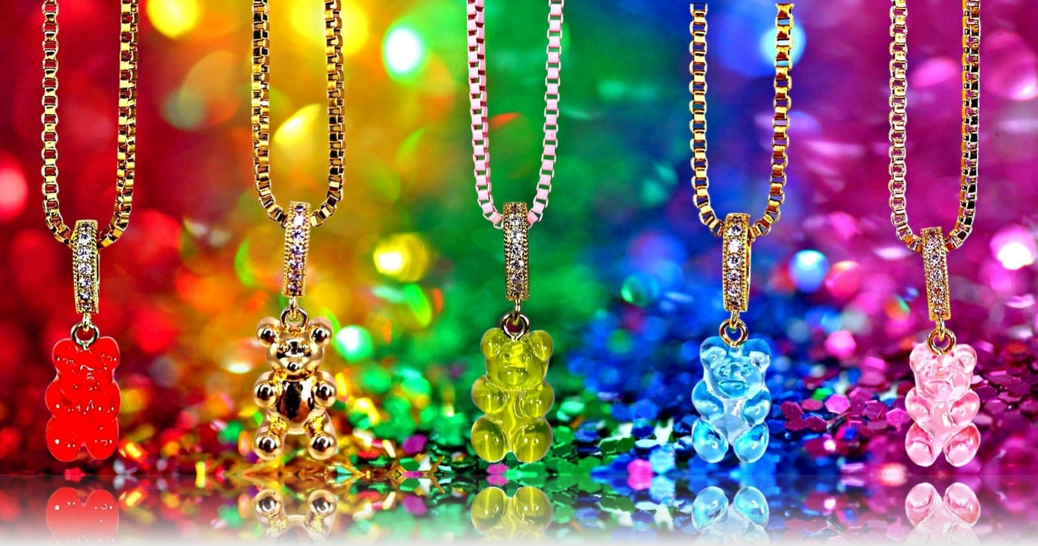 5 Gummy Bear Pendant Necklaces Line Up Infront Of A Rainbow Colored Backdrop - Gummy Bear Bling Jewelry